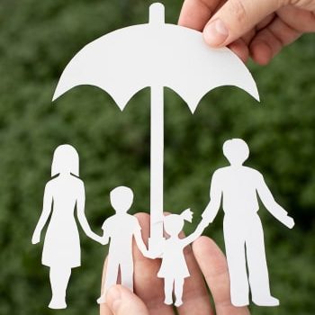 close-up-hands-holding-paper-family-outdoors 1
