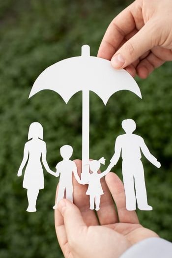 close-up-hands-holding-paper-family-outdoors 1